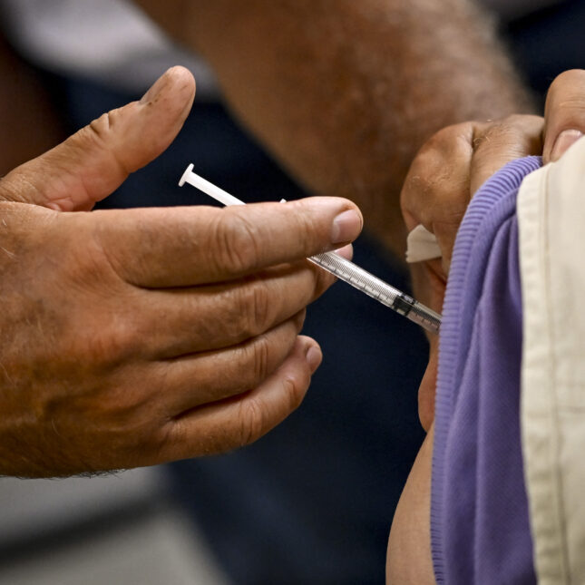 A person receiving a covid-19 booster vaccine . -- first opinion coverage from STAT