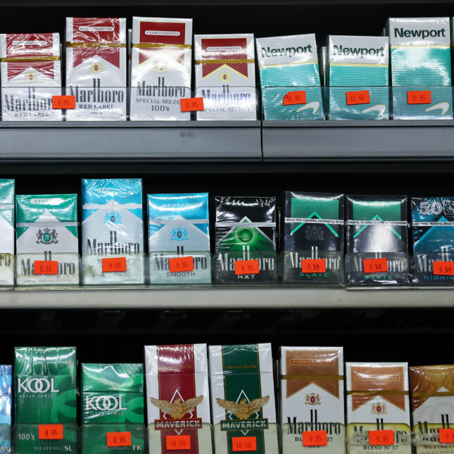 Packs of menthol-flavored and non-menthol cigarettes are displayed for sale in a smoke shop.